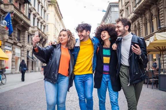 Group of young adults taking a selfie in a city